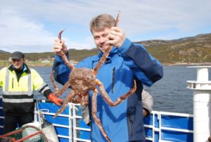 A man holds king crab