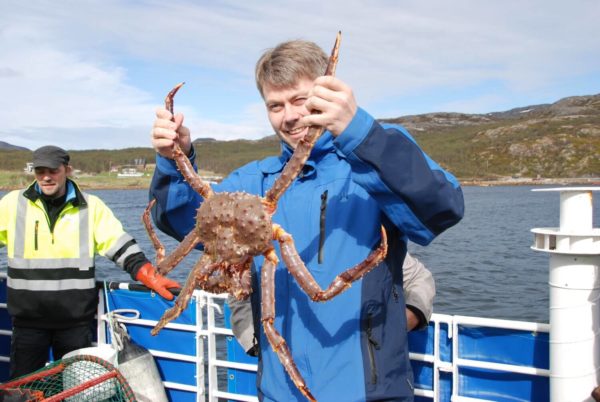 A man holds king crab