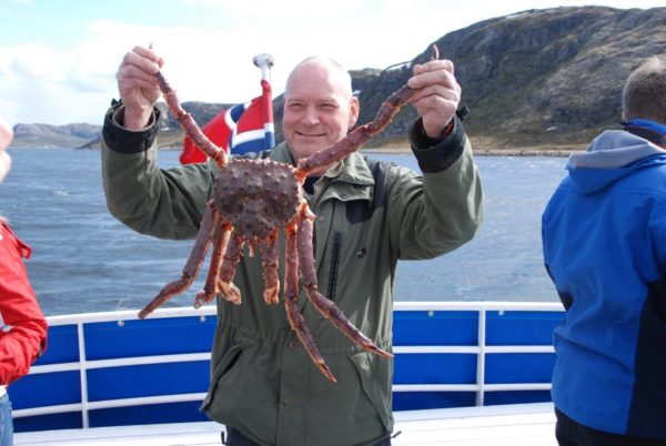 A man holds king crab