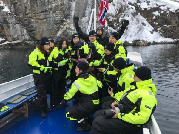Tourists holding king crab