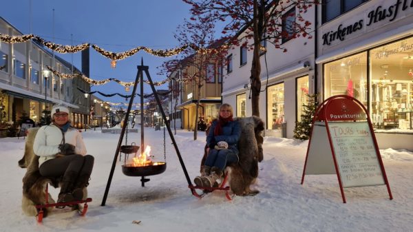 2 woman sit by the fire